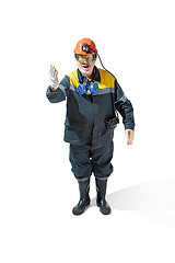 Image showing The studio shot of senior bearded male miner standing at the camera on a white background.