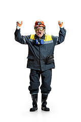 Image showing The studio shot of senior bearded male miner standing at the camera on a white background.