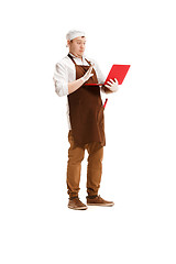 Image showing Surprised butcher posing with a laptop isolated on white background