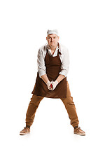 Image showing Angry aggressive butcher posing with a cleaver isolated on white background