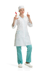 Image showing beautiful young woman doctor in medical robe holding syringe in hand.