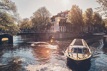 Image showing Amsterdam canal with tourist boat