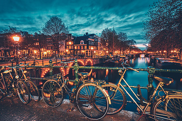 Image showing Amterdam canal, bridge and medieval houses in the evening