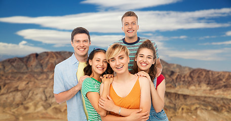 Image showing happy friends over grand canyon background