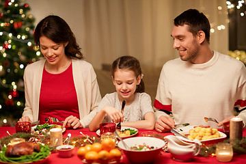 Image showing happy family having christmas dinner at home