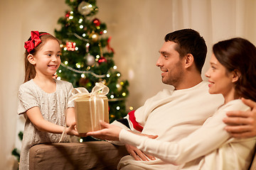 Image showing happy family with christmas present at home