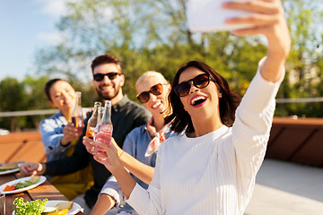 Image showing happy friends taking selfie at rooftop party