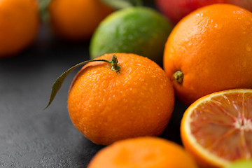 Image showing close up of citrus fruits on stone table