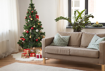 Image showing christmas tree, gifts and sofa at cozy home