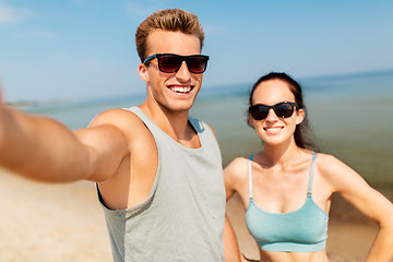 Image showing couple taking selfie by smartphone on beach