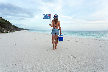 Image showing Aussie beach culture  Woman walking on beach with esky