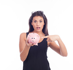 Image showing Young woman hold a piggy bank