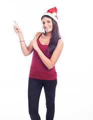 Image showing Happy christmas woman pointing