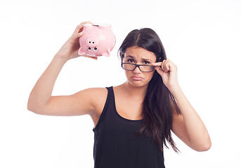 Image showing Young woman worried with a piggy bank