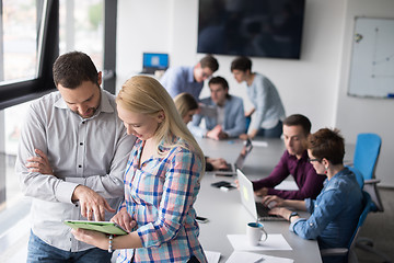 Image showing Two Business People Working With Tablet in office