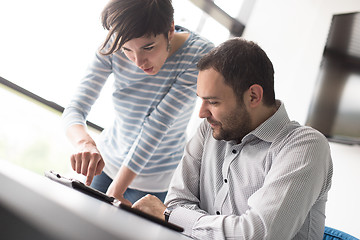 Image showing Two Business People Working With Tablet in startup office