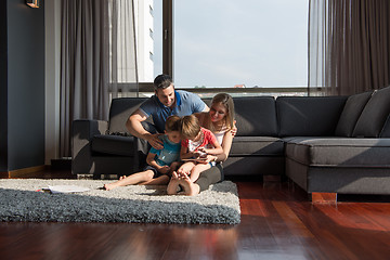 Image showing happy young couple spending time with kids