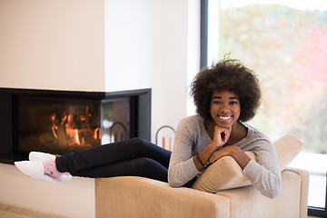 Image showing black woman in front of fireplace