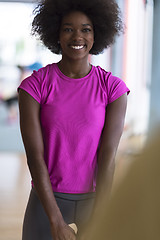 Image showing woman working out in a crossfit gym with dumbbells