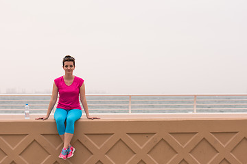 Image showing young woman sitting after a successful training run