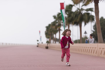 Image showing mother and cute little girl on the promenade by the sea