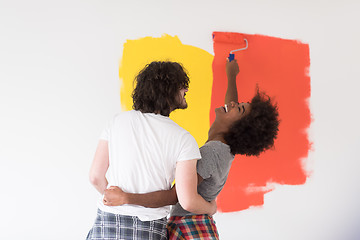 Image showing multiethnic couple painting interior wall