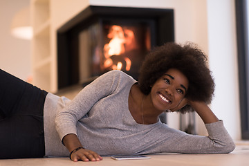 Image showing black women using tablet computer on the floor