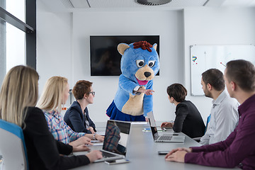 Image showing boss dresed as bear having fun with business people in trendy of