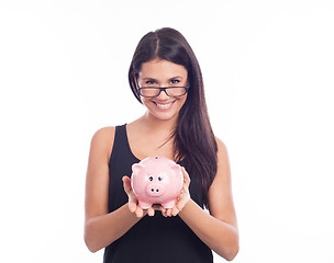 Image showing Young woman with glasses happy with piggy bank