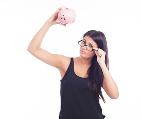 Image showing Young woman worried with a piggy bank