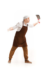 Image showing Angry aggressive butcher posing with a cleaver isolated on white background