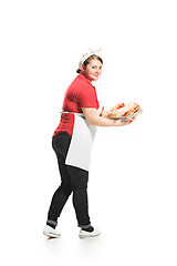 Image showing Portrait of cute smiling woman with pastries in her hands in the studio, isolated on white background