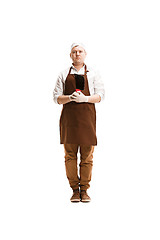 Image showing Smiling butcher posing with a cleaver isolated on white background