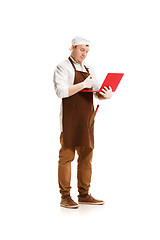 Image showing Serious butcher posing with a laptop isolated on white background