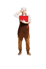 Image showing Sorry butcher posing with a laptop isolated on white background
