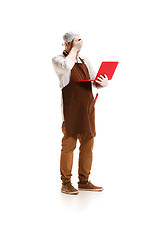 Image showing Sorry butcher posing with a laptop isolated on white background