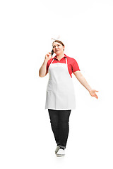 Image showing Portrait of cute smiling woman with mobile phone in her hands in the studio, isolated on white background