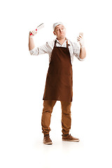 Image showing Smiling butcher posing with a cleaver isolated on white background