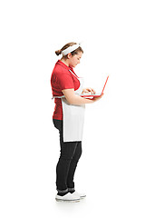 Image showing Portrait of cute smiling woman with laptop in her hands in the studio, isolated on white background