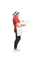 Image showing Portrait of cute smiling woman with laptop in her hands in the studio, isolated on white background