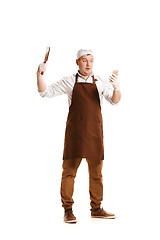 Image showing Smiling butcher posing with a cleaver isolated on white background