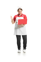 Image showing Portrait of cute smiling woman with laptop in her hands in the studio, isolated on white background