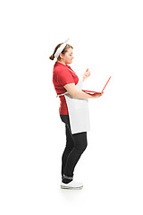 Image showing Portrait of cute smiling woman with laptop in her hands in the studio, isolated on white background