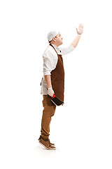 Image showing Smiling butcher posing with a cleaver isolated on white background