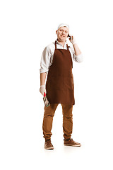 Image showing Smiling butcher posing with a cleaver isolated on white background