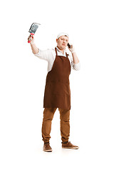 Image showing Smiling butcher posing with a cleaver isolated on white background