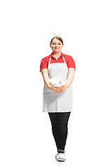 Image showing Portrait of cute smiling woman with bowl in her hands in the studio, isolated on white background