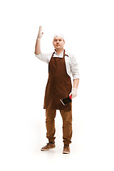 Image showing Smiling butcher posing with a cleaver isolated on white background