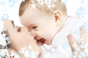 Image showing happy mother kissing baby boy