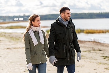 Image showing couple walking along autumn beach